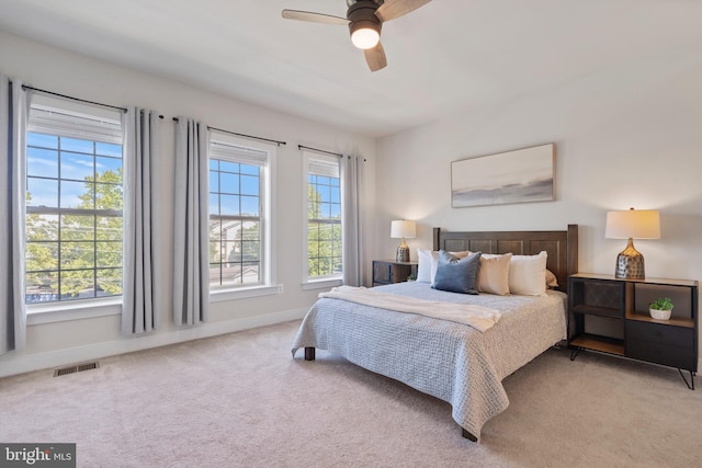 bedroom featuring carpet flooring, ceiling fan, baseboards, and visible vents