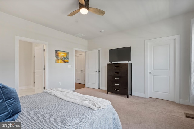 bedroom featuring visible vents, light carpet, baseboards, and a ceiling fan