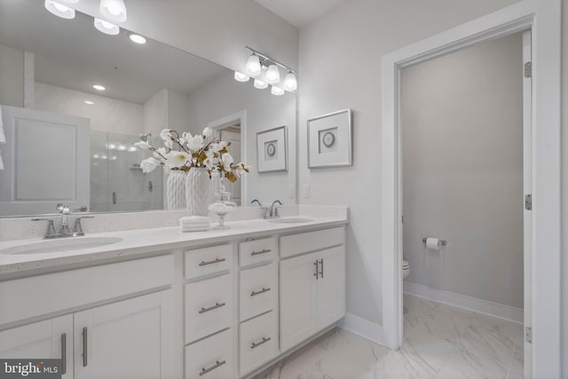 bathroom with a sink, baseboards, marble finish floor, and a shower stall