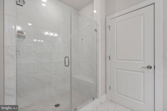 full bathroom with marble finish floor and a stall shower