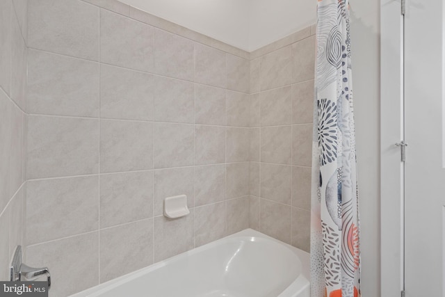 bathroom with shower / bathtub combination with curtain