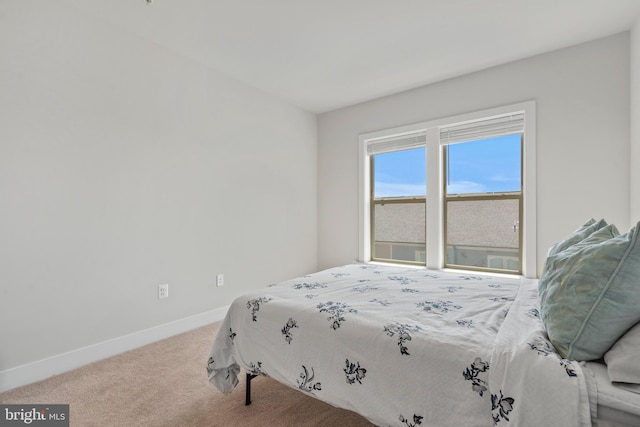 bedroom featuring baseboards and carpet flooring