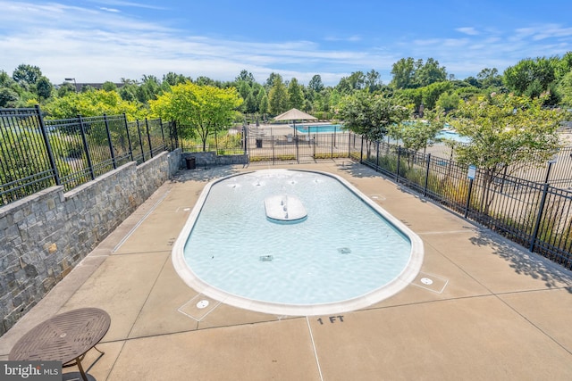 view of pool with a fenced in pool and fence