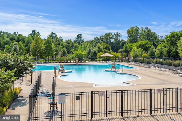 pool featuring a patio area and fence