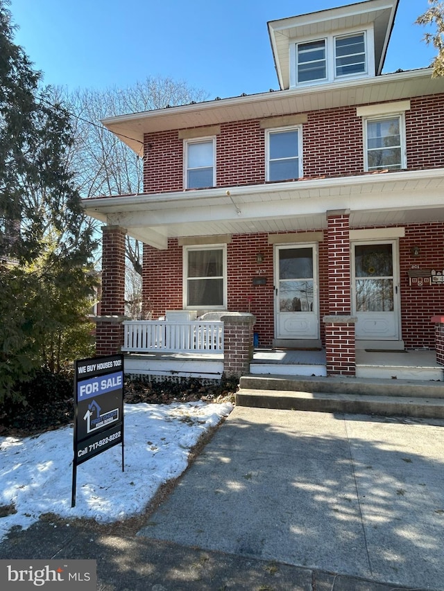 traditional style home with brick siding and a porch