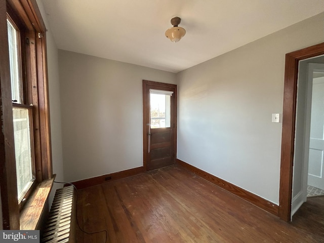 entrance foyer with dark wood finished floors and baseboards