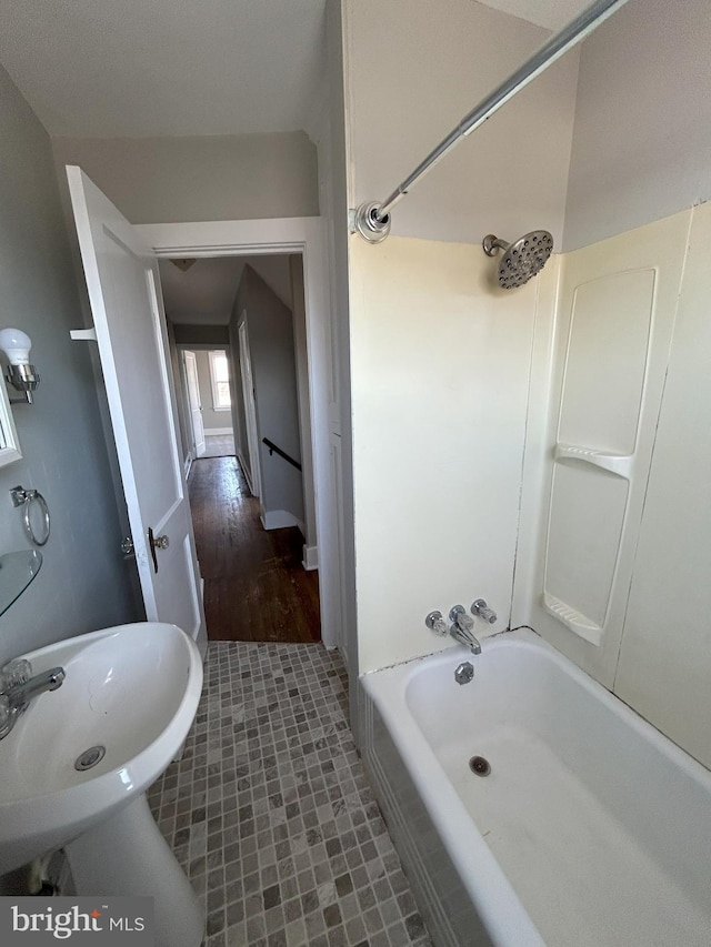 bathroom with tub / shower combination and a sink