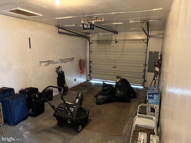 garage with electric panel and a garage door opener