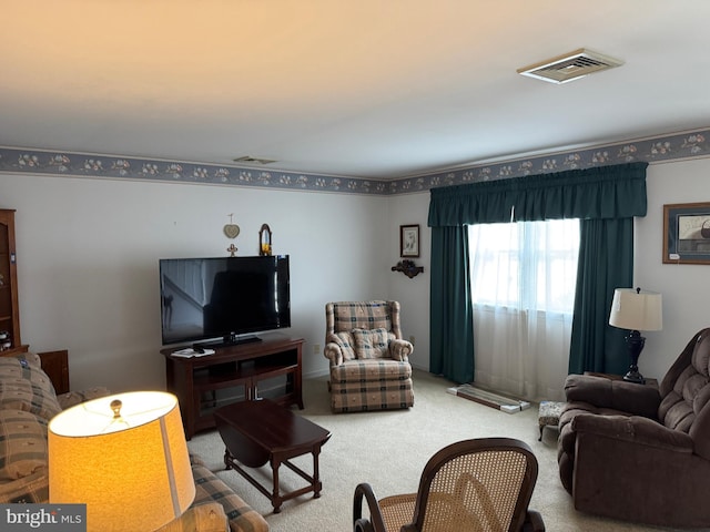 living area featuring carpet flooring and visible vents