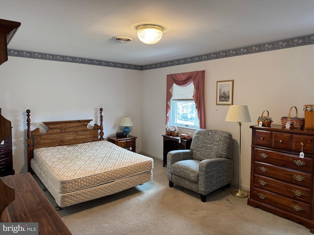 carpeted bedroom featuring visible vents