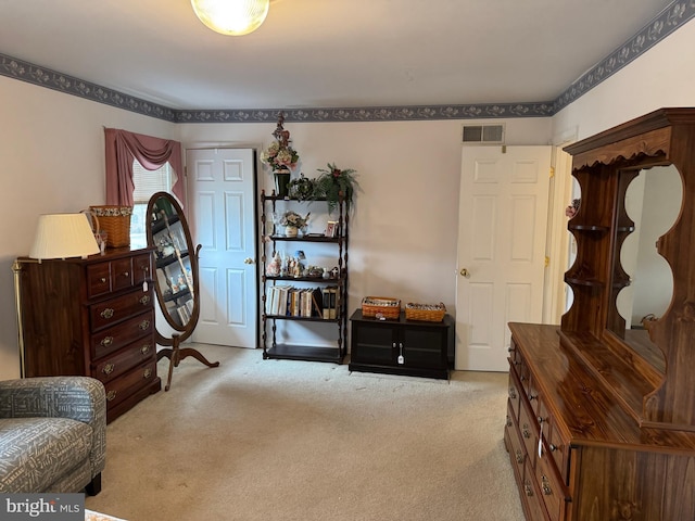 living area with visible vents and carpet floors