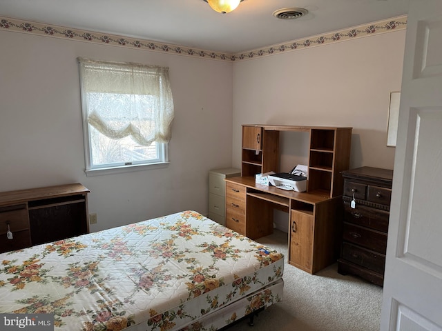 bedroom with light colored carpet and visible vents