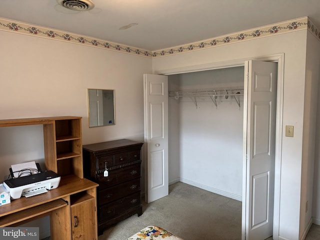 bedroom featuring visible vents, a closet, and light carpet