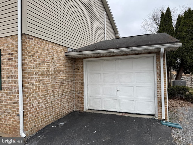 garage with aphalt driveway