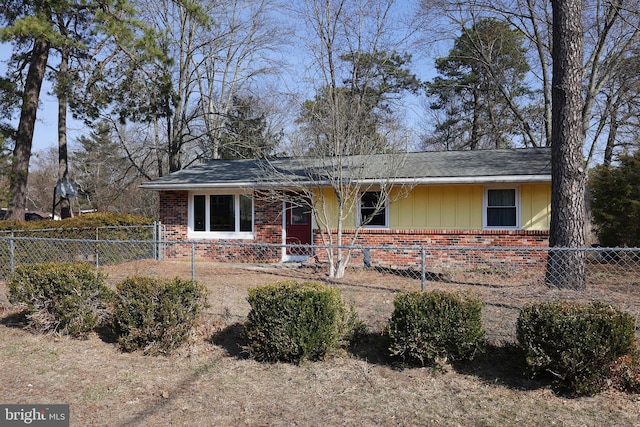 single story home with brick siding, board and batten siding, and a fenced front yard