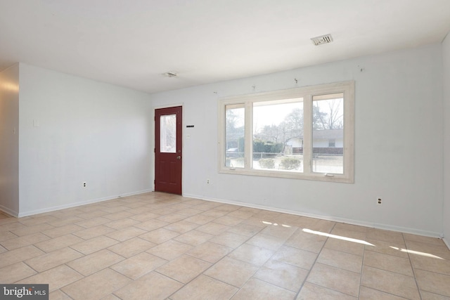 foyer featuring light tile patterned floors, visible vents, and baseboards