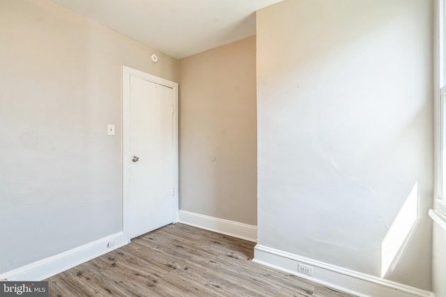 spare room with wood finished floors and baseboards