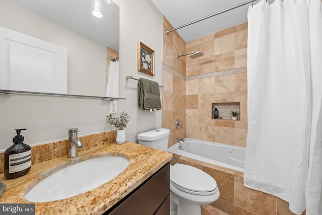 full bathroom featuring tiled shower / bath, toilet, and vanity