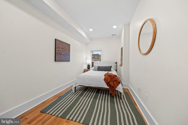 bedroom featuring visible vents, recessed lighting, wood finished floors, and baseboards