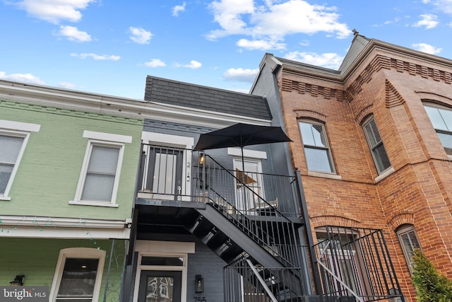 exterior space with stairs and brick siding