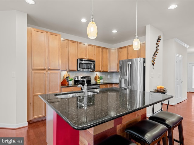 23811 Pembroke Ln, Millville, DE 19967 - kitchen with baseboards, a sink, dark wood-style flooring, a breakfast bar, and stainless steel appliances