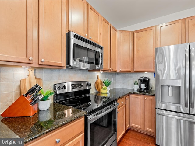 23811 Pembroke Ln, Millville, DE 19967 - kitchen with stainless steel appliances, tasteful backsplash, light wood finished floors, and dark stone countertops