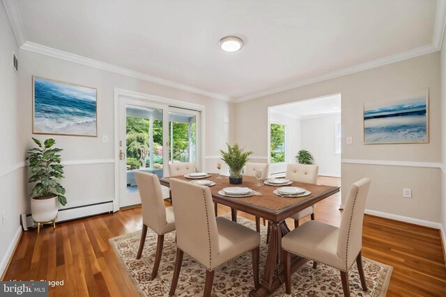 dining room featuring ornamental molding, light wood finished floors, visible vents, and a wealth of natural light
