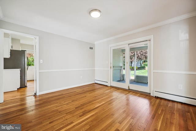 empty room featuring baseboard heating, light wood-style floors, a baseboard radiator, visible vents, and ornamental molding