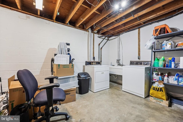 unfinished basement with independent washer and dryer and concrete block wall