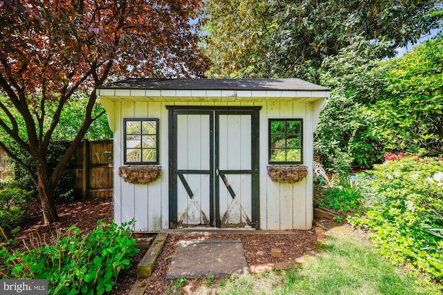 view of shed with fence