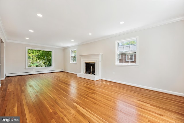 unfurnished living room with a fireplace, baseboards, a baseboard radiator, light wood finished floors, and ornamental molding