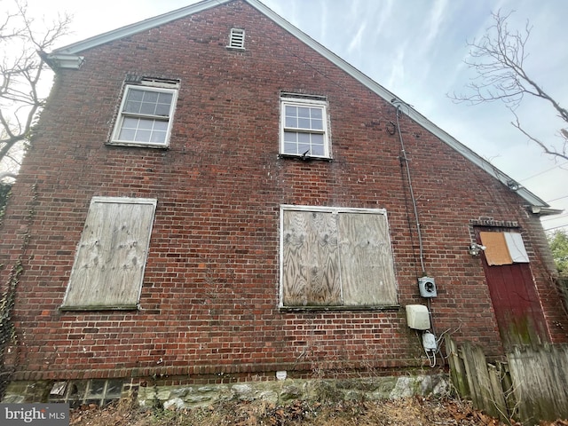 view of side of property with brick siding