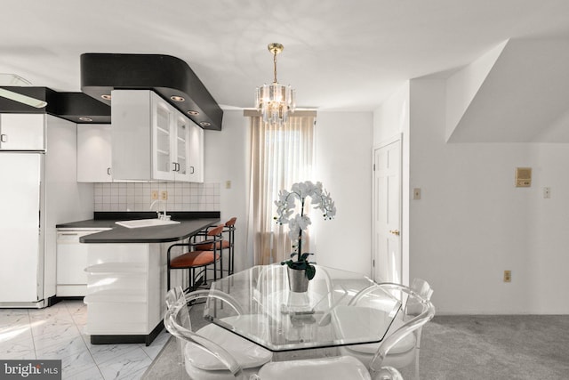 dining room with an inviting chandelier and marble finish floor