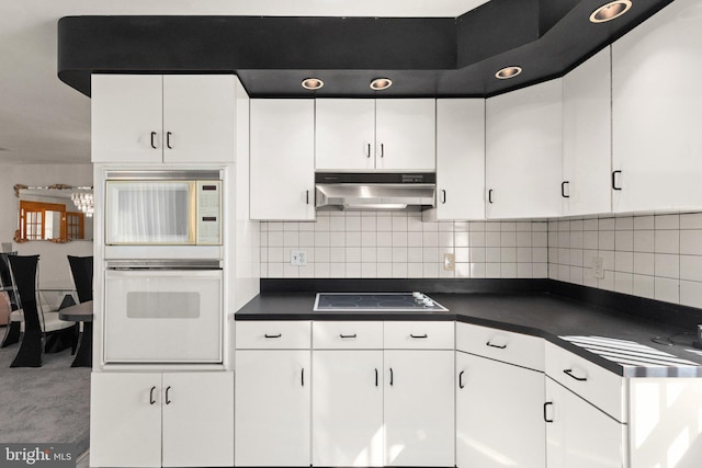 kitchen with white cabinetry, black electric cooktop, and under cabinet range hood