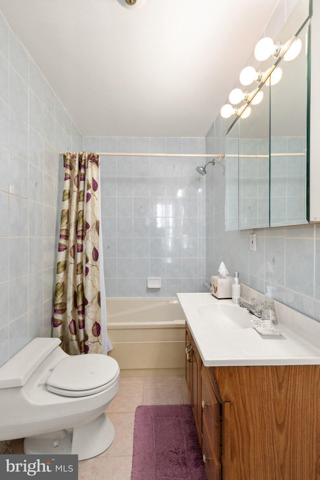 full bathroom with vanity, tile patterned flooring, shower / bath combination with curtain, tile walls, and toilet