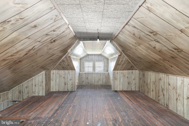 bonus room with vaulted ceiling, wooden walls, and hardwood / wood-style flooring