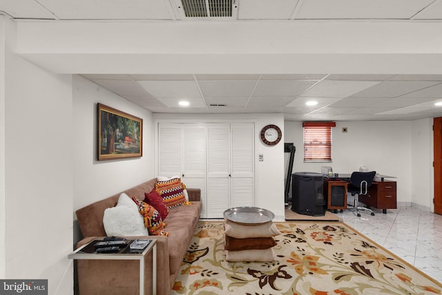 living area with visible vents, baseboards, recessed lighting, a paneled ceiling, and marble finish floor