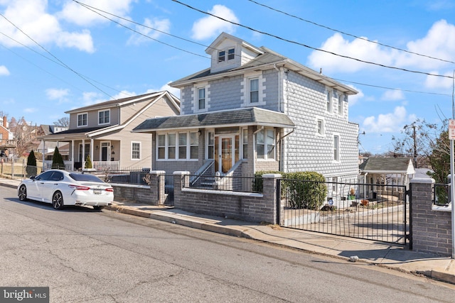 traditional style home featuring a fenced front yard and a residential view