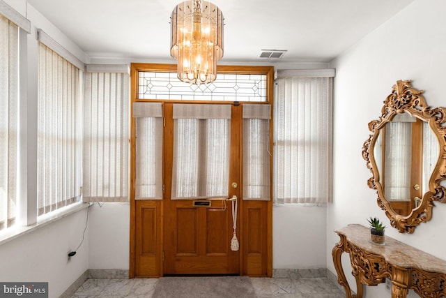 entrance foyer featuring a notable chandelier, baseboards, visible vents, and marble finish floor