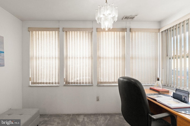 home office featuring a notable chandelier, visible vents, and carpet floors