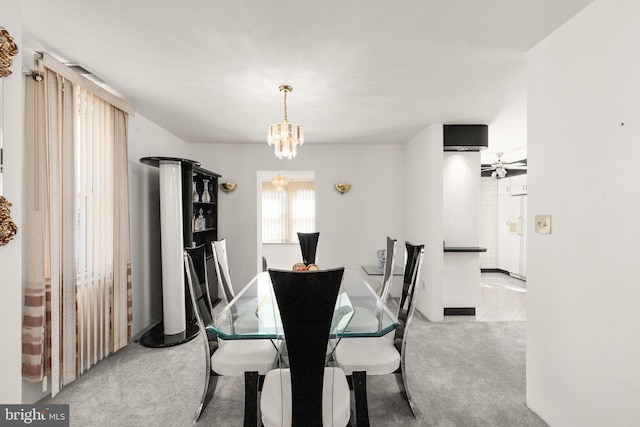 dining room featuring a notable chandelier and carpet