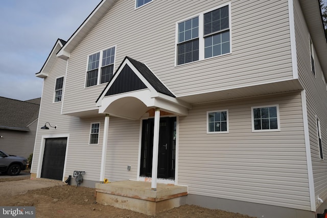 rear view of house with an attached garage