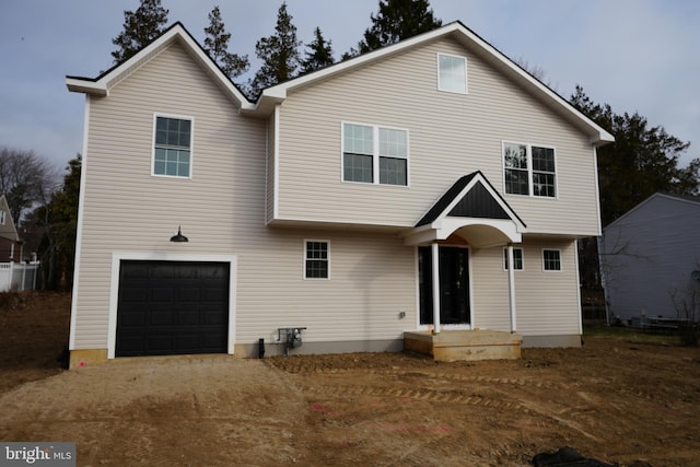 rear view of house with a garage