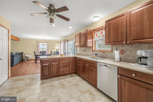 4270 Beulah Rd, Hurlock, MD 21643 - kitchen with ceiling fan with notable chandelier, decorative backsplash, stainless steel dishwasher, a sink, and a peninsula