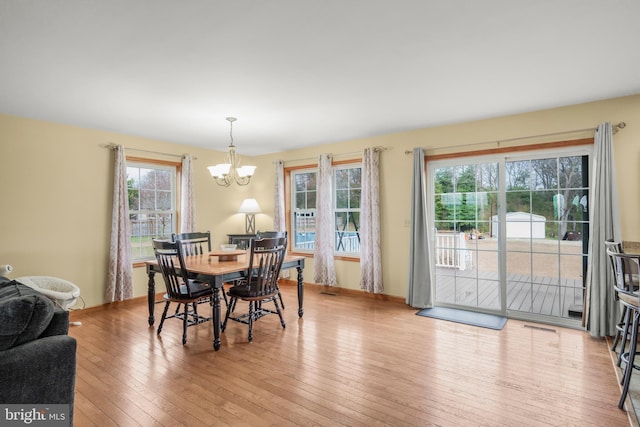4270 Beulah Rd, Hurlock, MD 21643 - dining space with light wood finished floors, visible vents, and an inviting chandelier