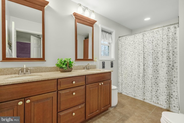 4270 Beulah Rd, Hurlock, MD 21643 - bathroom with double vanity, toilet, tile patterned flooring, and a sink