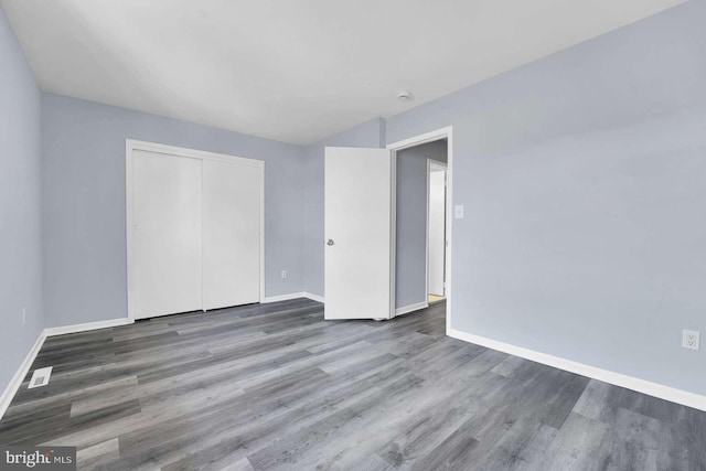 interior space with wood finished floors and baseboards