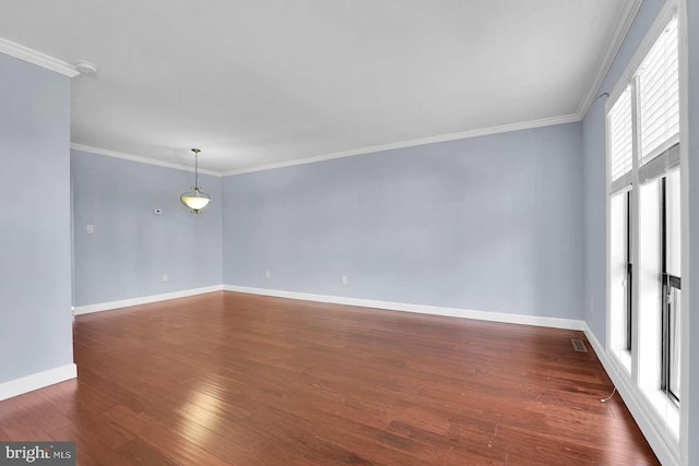 unfurnished room featuring visible vents, crown molding, dark wood-type flooring, and baseboards