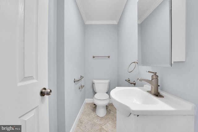 bathroom with crown molding, toilet, baseboards, and a sink