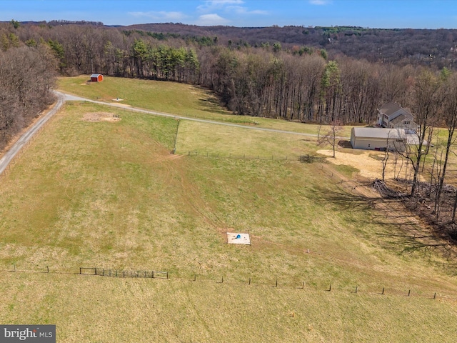 bird's eye view with a view of trees and a rural view